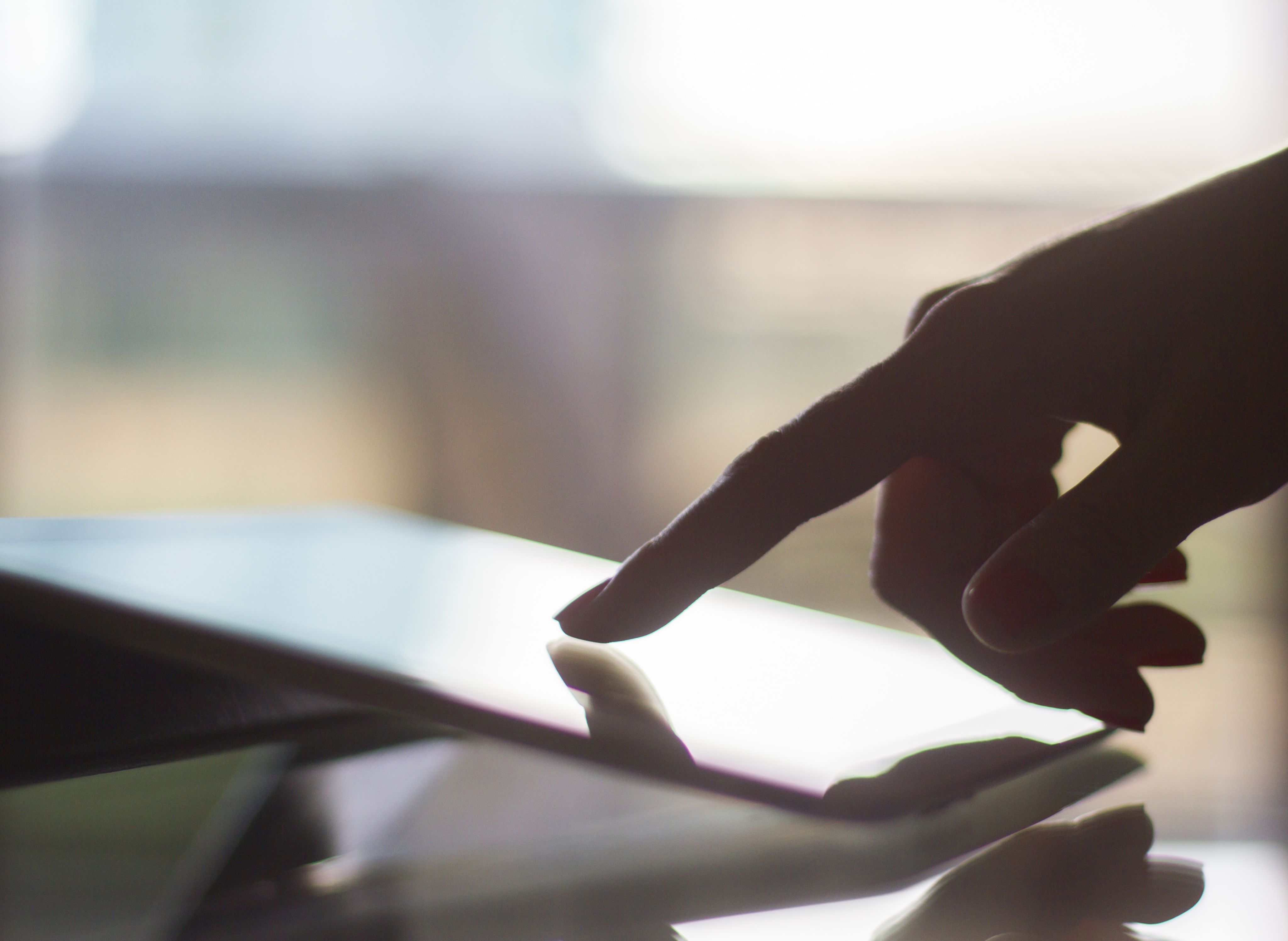 Person using finger to scroll on a tablet