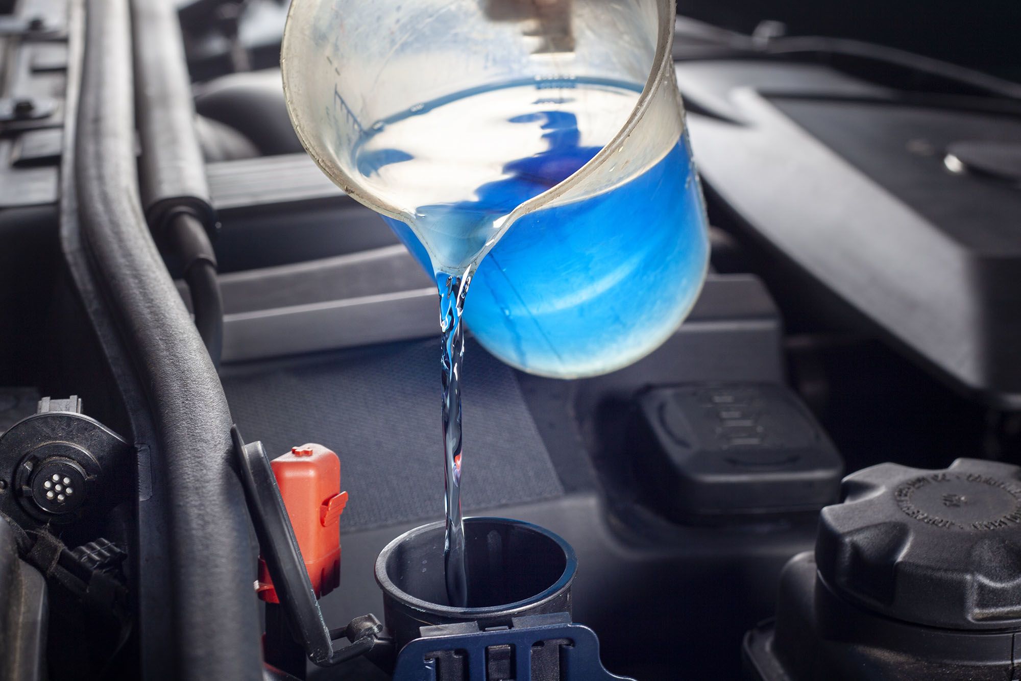 Antifreeze being poured into a car