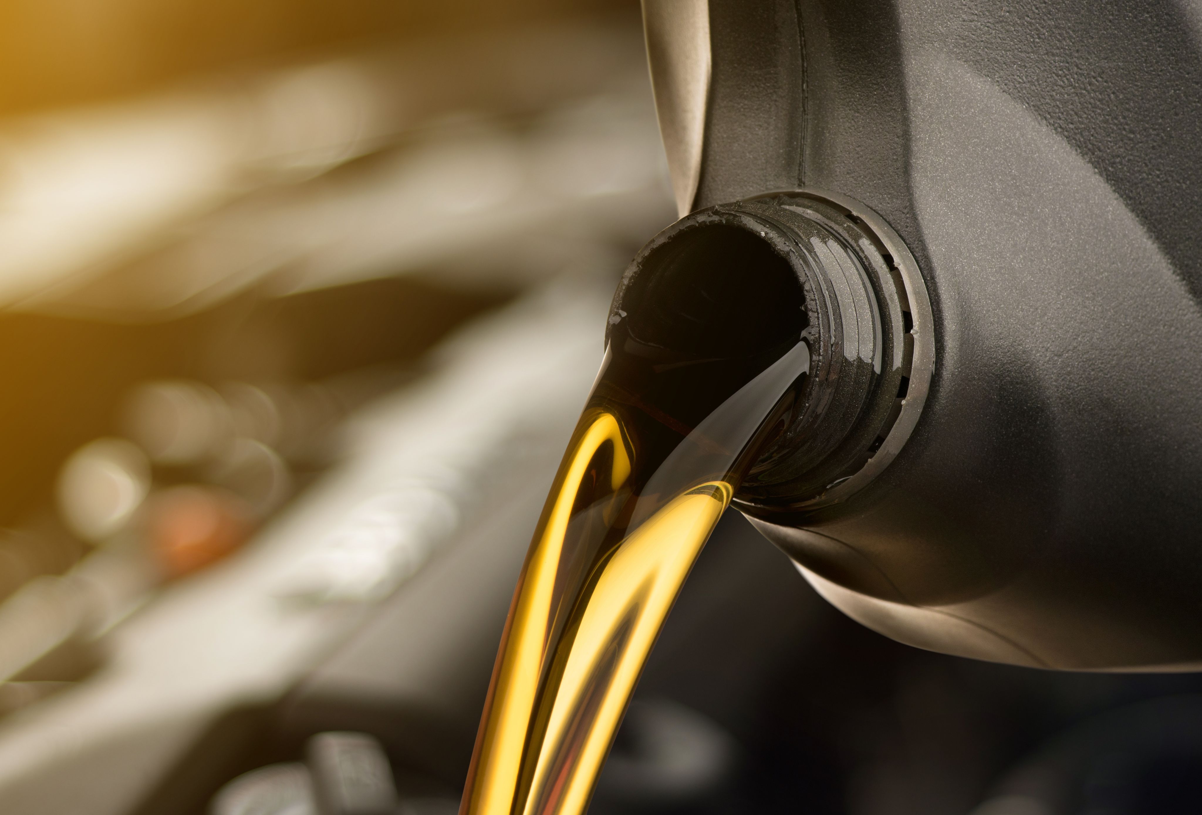 Motor oil being poured into a car