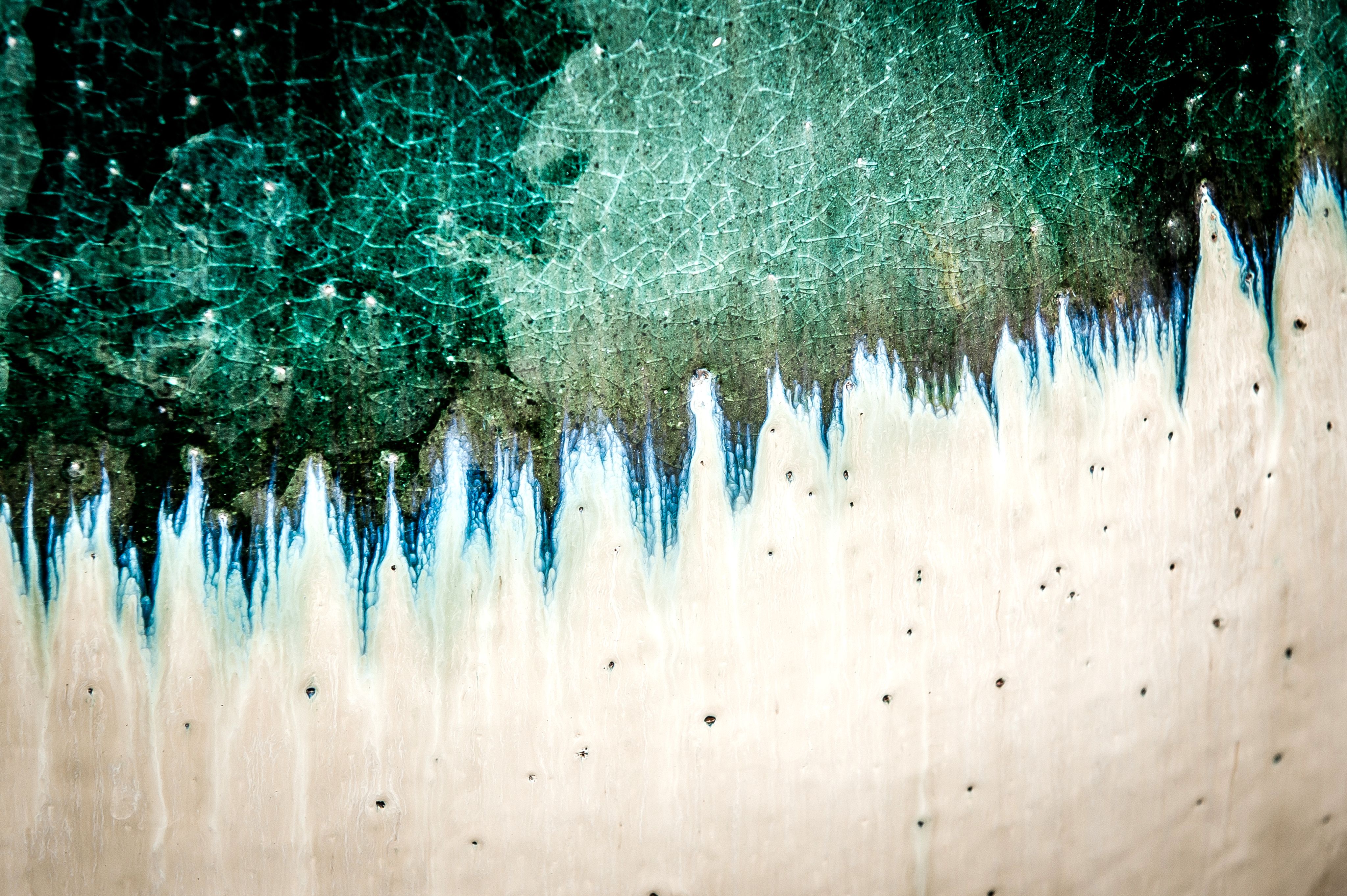 Close up of ceramic glaze on decorative pottery (green and creame)