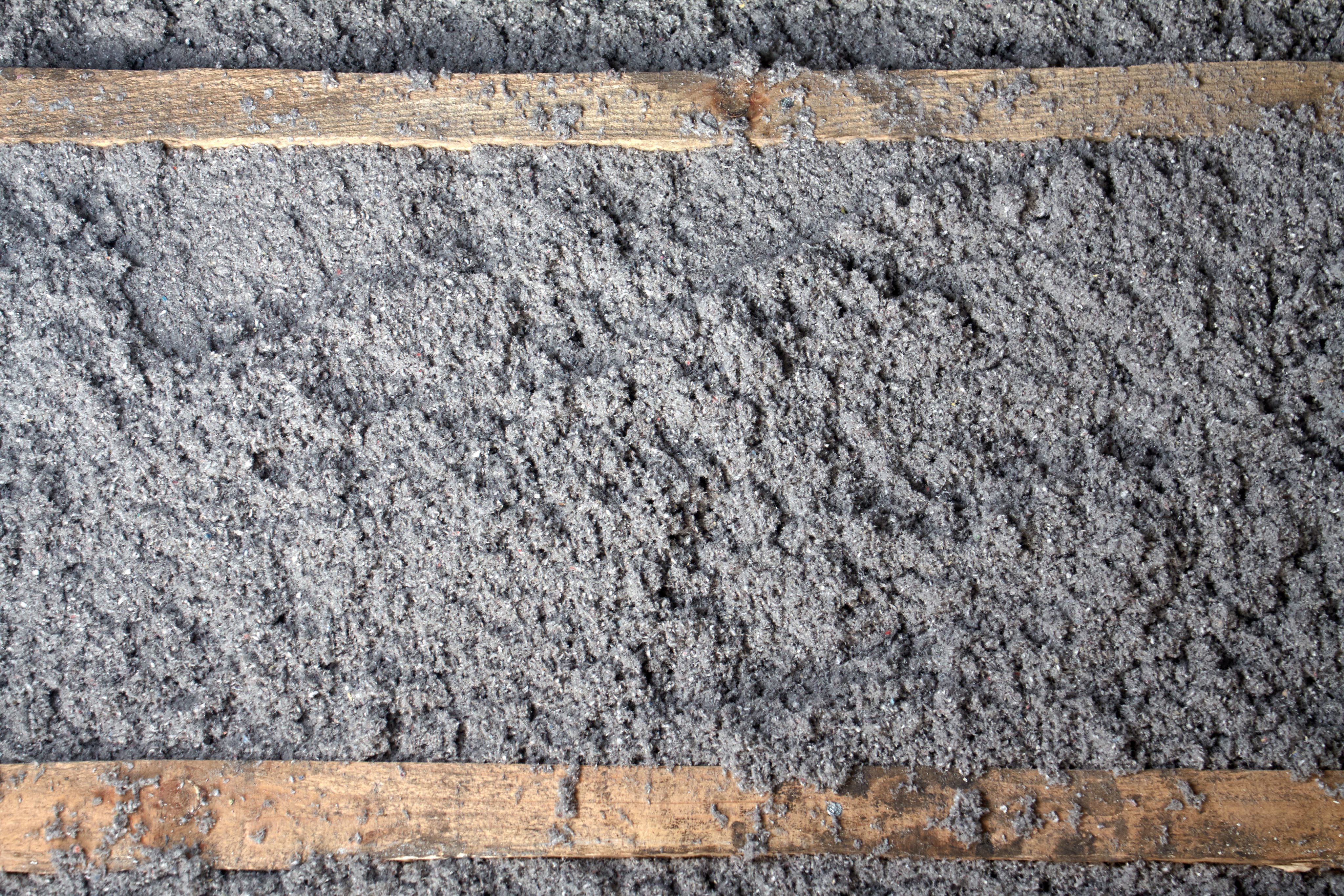 Cellulose insulation between wood beams in wall construction