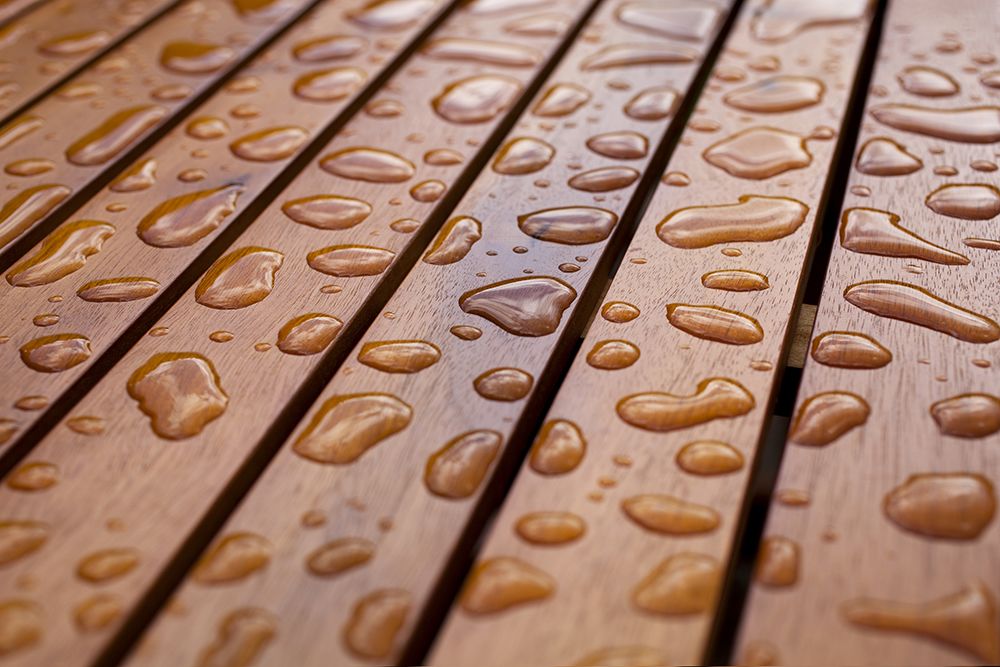 Close up of water droplets on wood decking