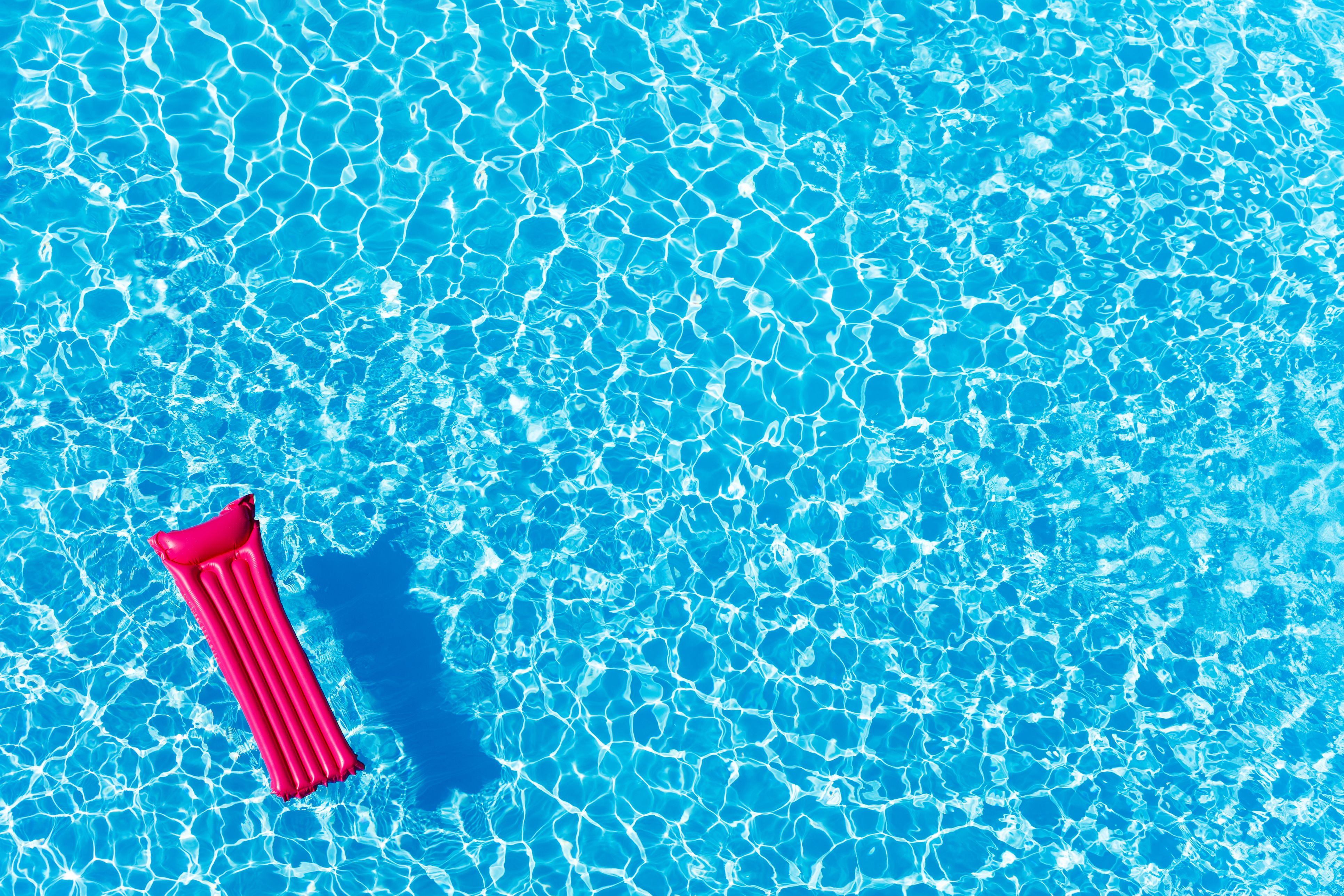 An inflatable floating in a clear blue pool